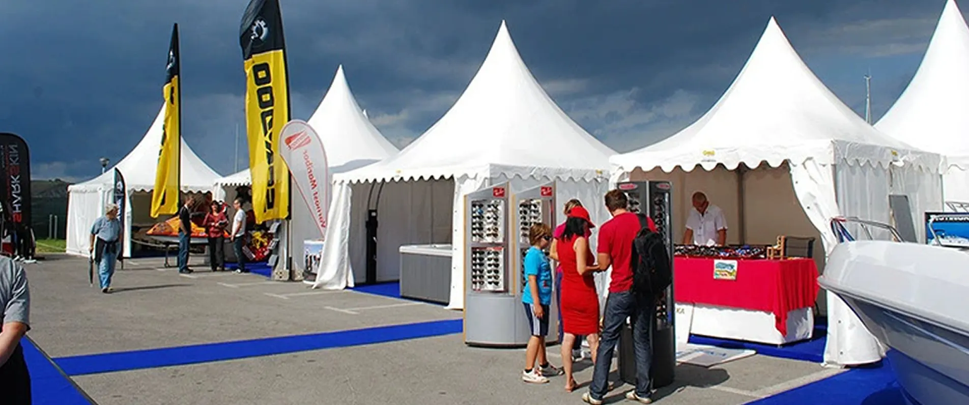 trade show tent with side walls and branded canopy at an outdoor expo trade show tent with side walls and branded canopy at an outdoor expo